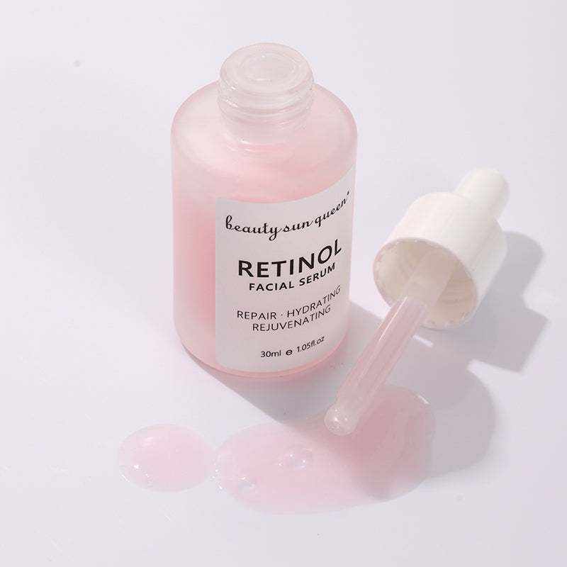 Sérum visage au rétinol rose dans un flacon en verre avec pipette blanche et texture déposée